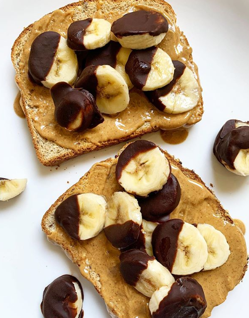 close us shot of two slices of Country Harvest Ancient Grain slices, spread with peanut butter and topped with dark chocolate dipped banana slices
