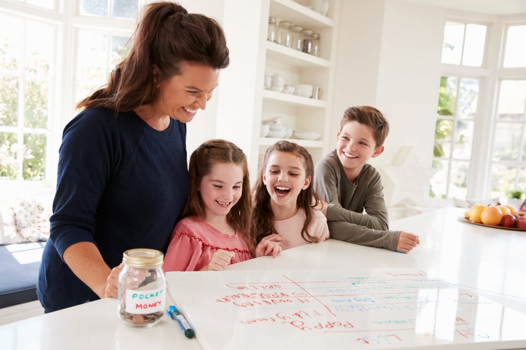 Country Harvest Tip 2 for Getting Organized - Mother and 3 children looking at a white board with chores 