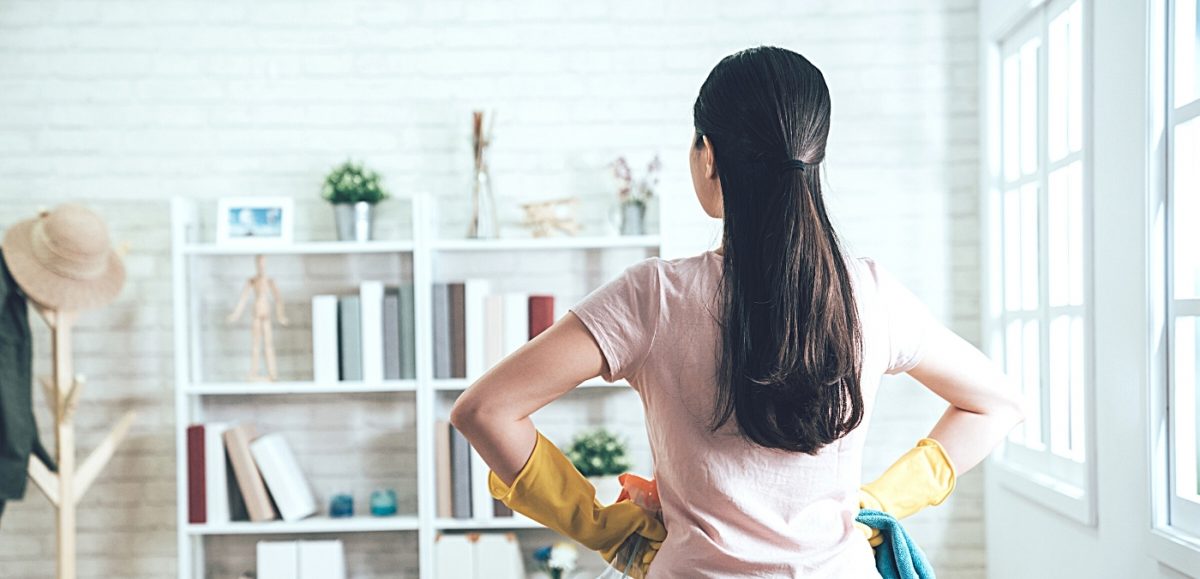 Country Harvest Tips to get Organized This Spring Blog , back of a women’s head facing a tidy room holding cleaning supplies